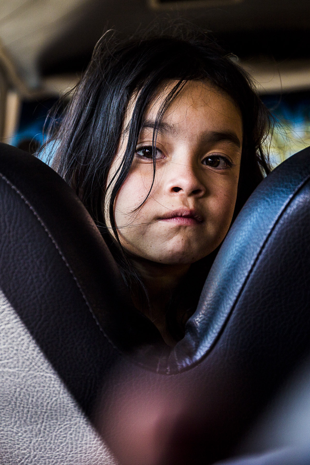 little kid staring at the camera on a bus Honduras